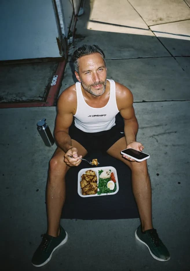 Man eating a healthy meal outdoors after a workout